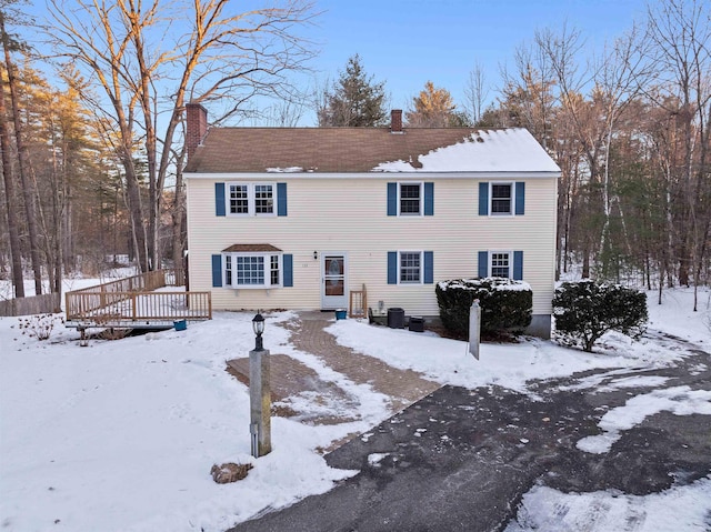 colonial inspired home with a wooden deck