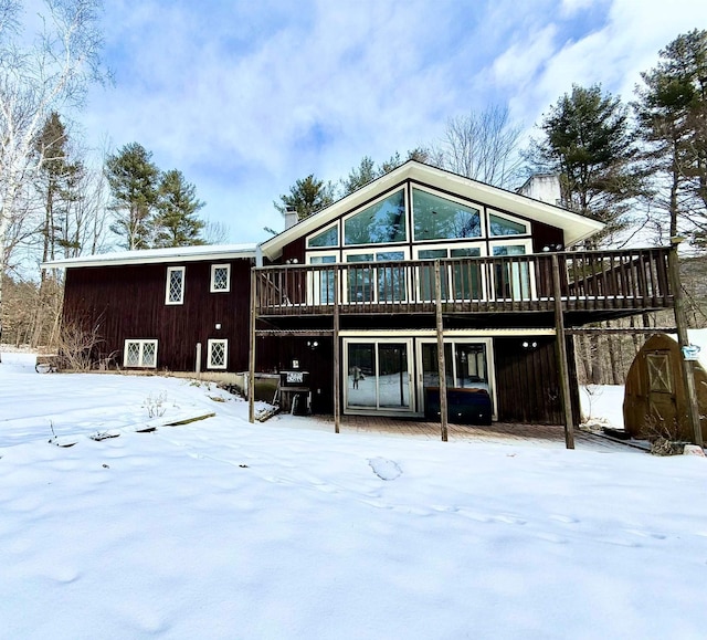 snow covered property featuring a wooden deck