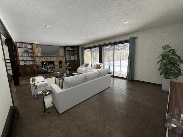 living room featuring built in features, a fireplace, and a textured ceiling