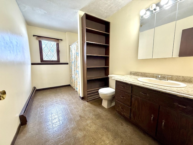 bathroom featuring vanity, a baseboard heating unit, a textured ceiling, and toilet