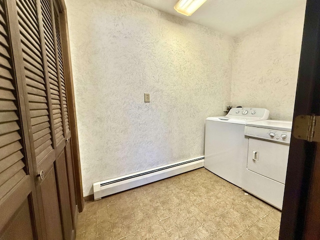 clothes washing area with a baseboard heating unit and independent washer and dryer