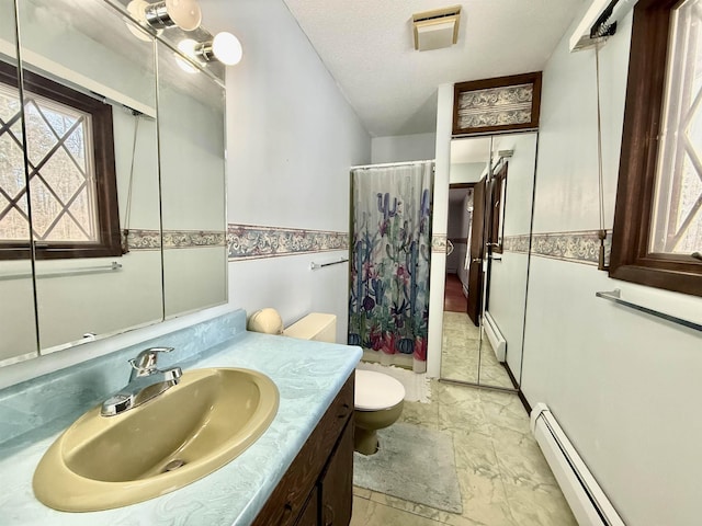 bathroom with vanity, a baseboard heating unit, a textured ceiling, and toilet