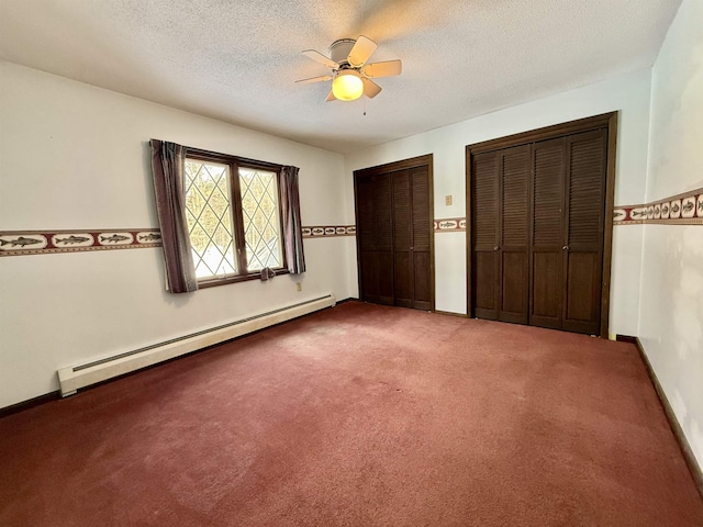 unfurnished bedroom with ceiling fan, carpet floors, a textured ceiling, two closets, and a baseboard radiator