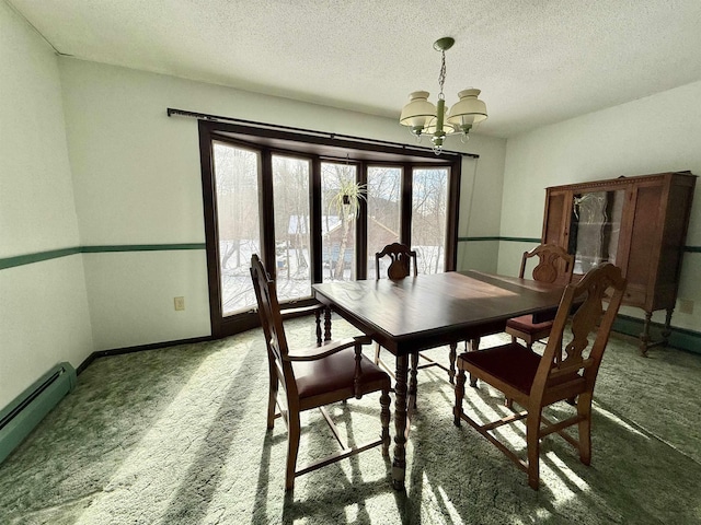 dining room with carpet floors, a textured ceiling, a notable chandelier, and baseboard heating