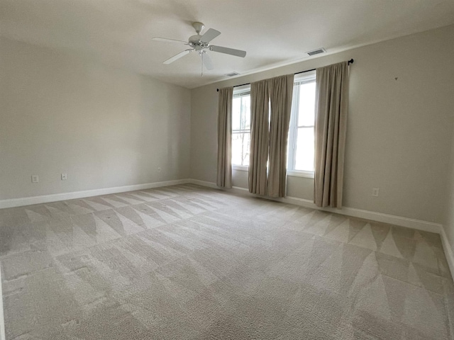 empty room with light carpet and ceiling fan