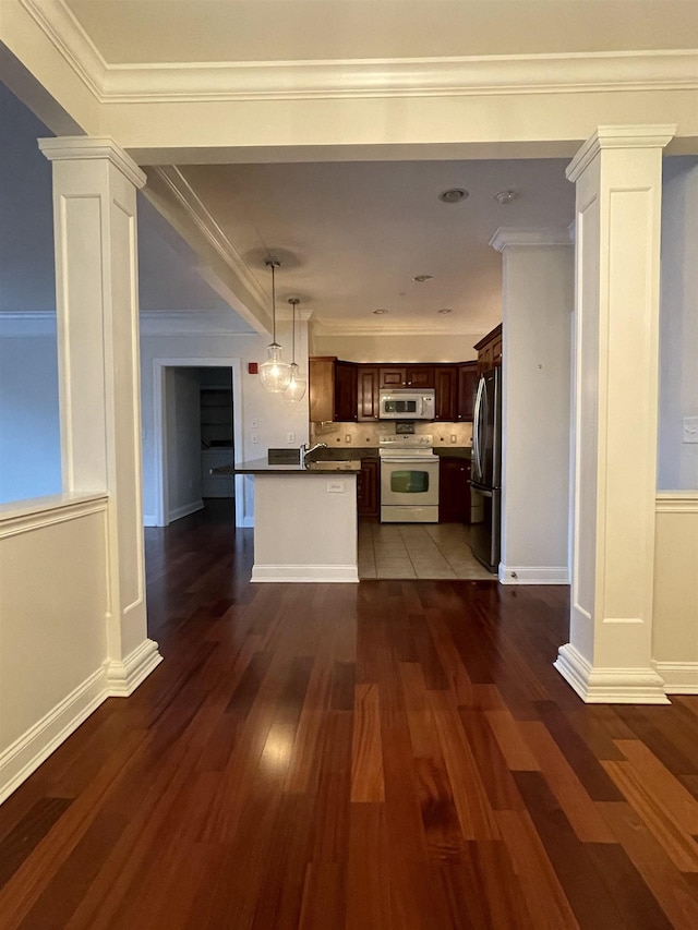 kitchen with ornate columns, stainless steel refrigerator, white range with electric stovetop, dark wood-type flooring, and dark brown cabinets