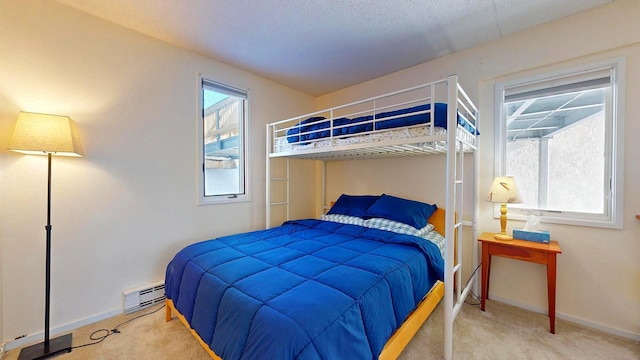 bedroom featuring a baseboard radiator and carpet flooring