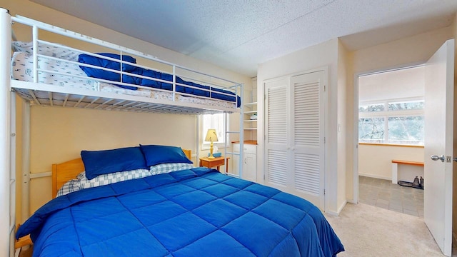 bedroom featuring a closet, carpet flooring, and a textured ceiling