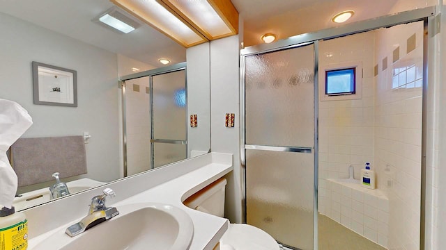 bathroom with vanity, toilet, and an enclosed shower