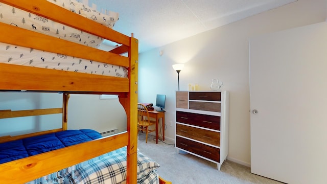 carpeted bedroom featuring a baseboard radiator