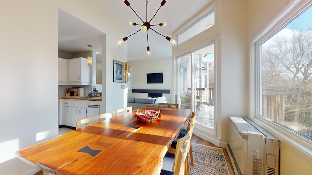 dining area featuring an inviting chandelier, plenty of natural light, and sink