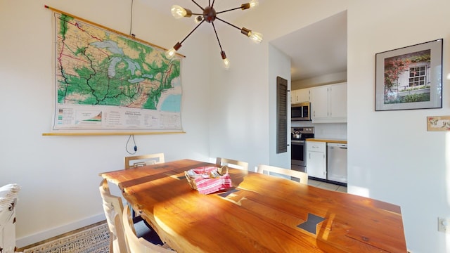 dining area featuring a notable chandelier and radiator heating unit