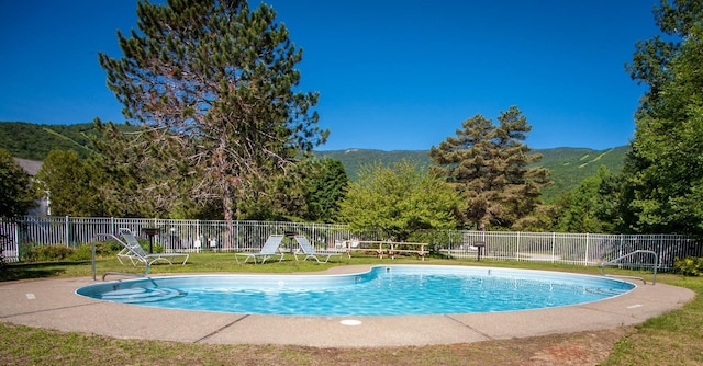 view of swimming pool with a mountain view