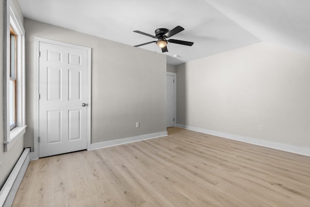 unfurnished bedroom featuring a baseboard heating unit, ceiling fan, and light hardwood / wood-style flooring