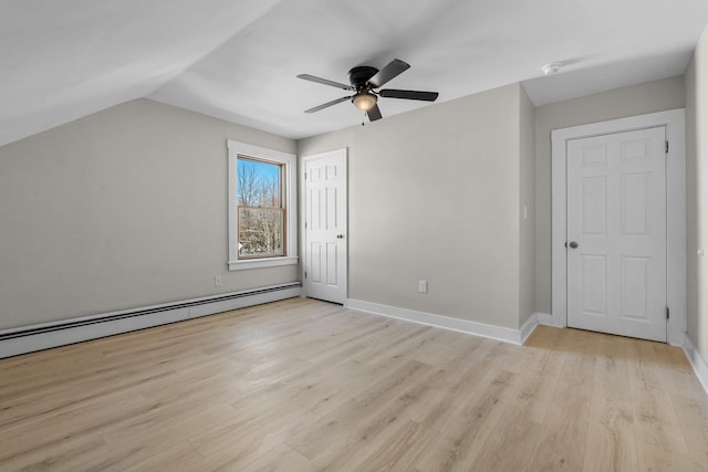 bonus room featuring a baseboard heating unit, light hardwood / wood-style flooring, ceiling fan, and vaulted ceiling