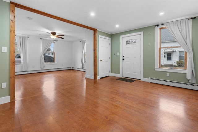 foyer with light hardwood / wood-style floors, ceiling fan, and baseboard heating