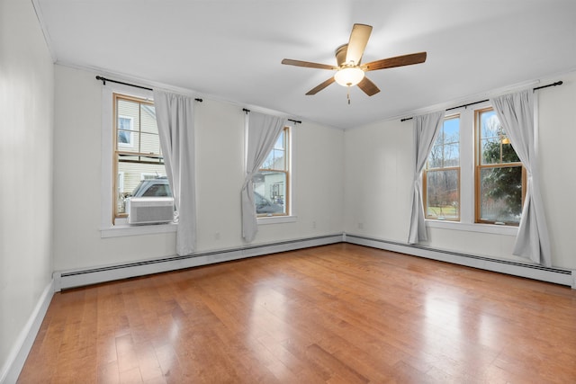 spare room featuring ceiling fan, crown molding, hardwood / wood-style floors, and baseboard heating