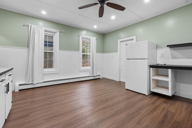 interior space featuring dark wood-type flooring, a baseboard radiator, and ceiling fan