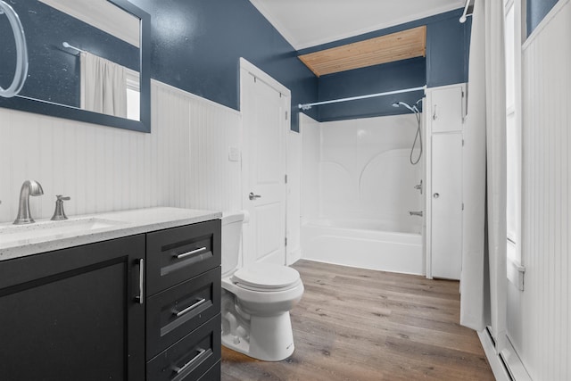 full bathroom with toilet, bathtub / shower combination, vanity, hardwood / wood-style flooring, and a baseboard heating unit