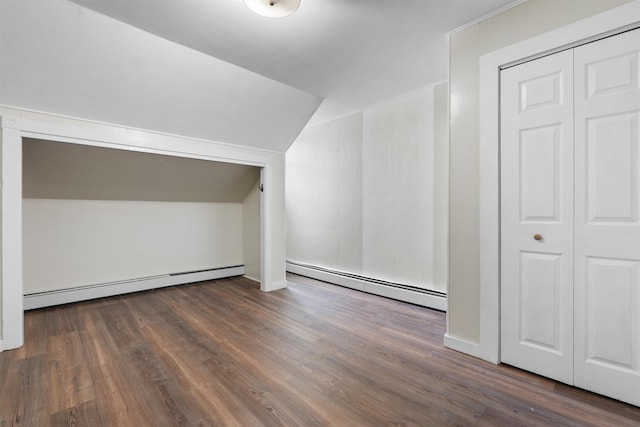 bonus room with a baseboard heating unit, dark wood-type flooring, and vaulted ceiling