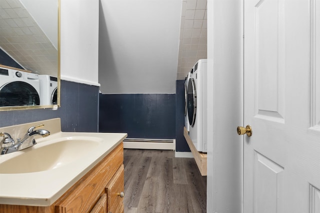 bathroom with hardwood / wood-style flooring, vanity, and baseboard heating