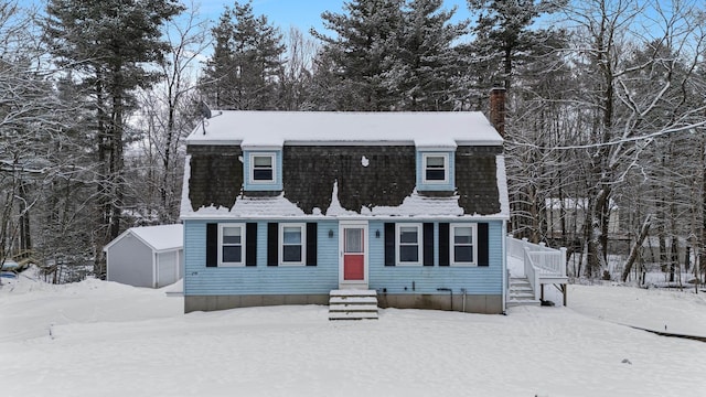 view of front of house featuring a garage and an outbuilding