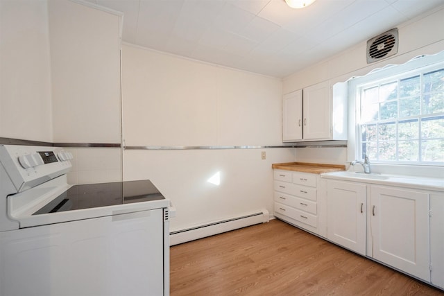 kitchen featuring washer / dryer, sink, white cabinets, a baseboard heating unit, and light hardwood / wood-style floors