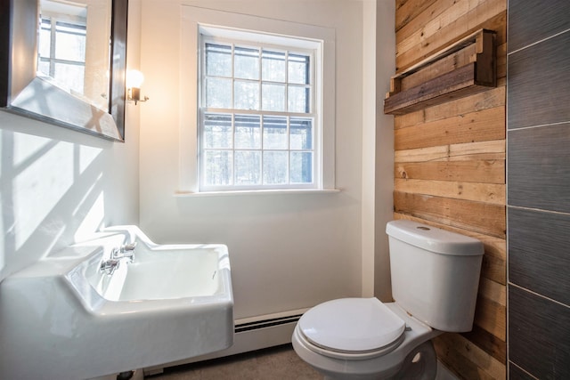 bathroom featuring wooden walls and toilet