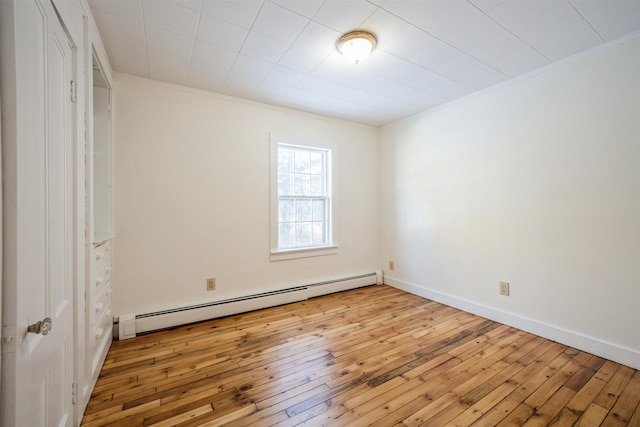 unfurnished room with light hardwood / wood-style flooring, crown molding, and a baseboard radiator