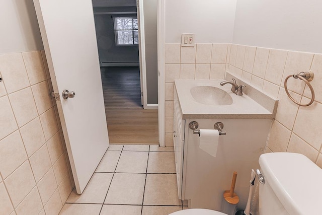 bathroom with vanity, tile walls, tile patterned floors, and toilet