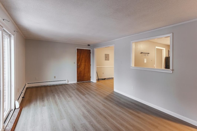 spare room with crown molding, a textured ceiling, light hardwood / wood-style floors, and baseboard heating