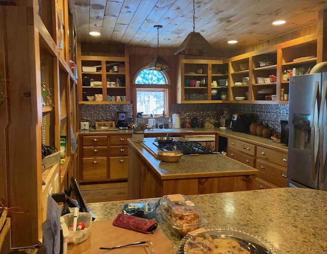 kitchen with appliances with stainless steel finishes, a center island, decorative backsplash, decorative light fixtures, and wooden ceiling