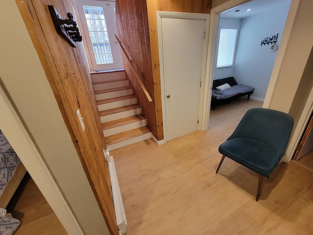 stairway featuring hardwood / wood-style floors and a wealth of natural light