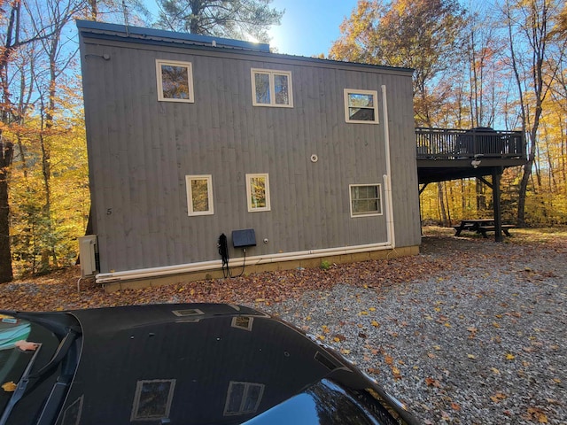 view of side of home with a wooden deck