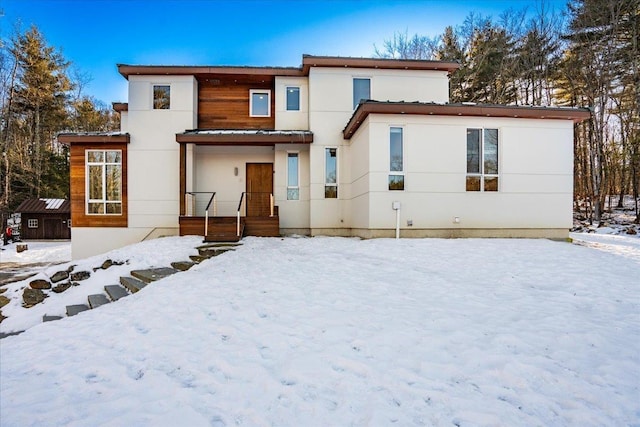 view of snow covered rear of property