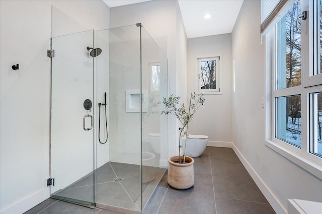 bathroom featuring toilet, tile patterned floors, and walk in shower