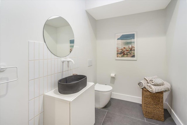 bathroom featuring vanity, tile patterned floors, and toilet