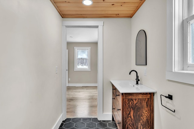 bathroom with tile patterned floors, vanity, and wooden ceiling