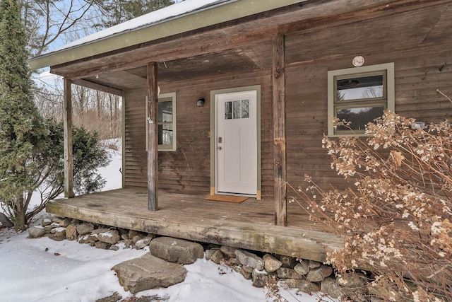 view of snow covered property entrance