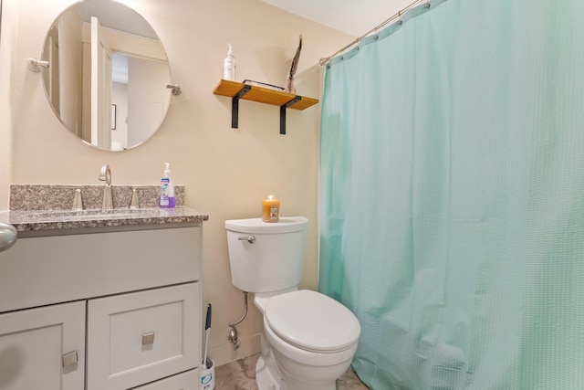 bathroom featuring walk in shower, vanity, and toilet