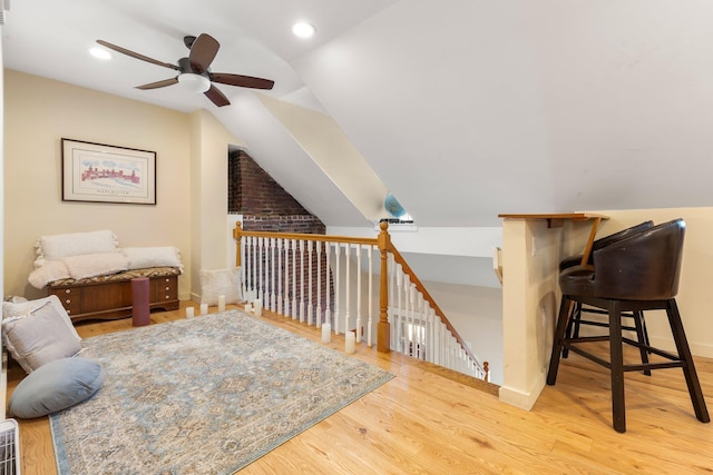 additional living space featuring ceiling fan, vaulted ceiling, and light hardwood / wood-style flooring