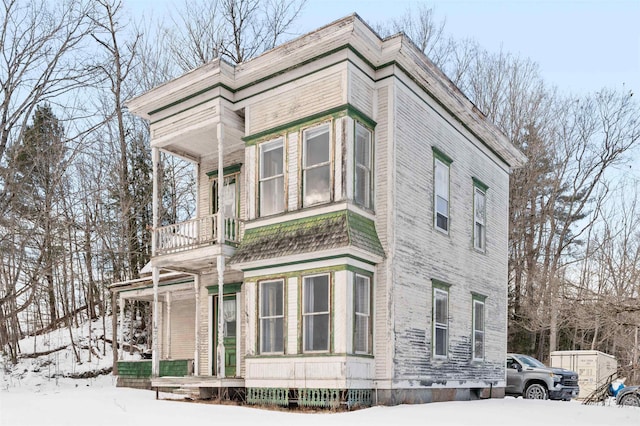 view of snow covered exterior featuring a porch