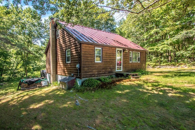 log cabin featuring a front lawn