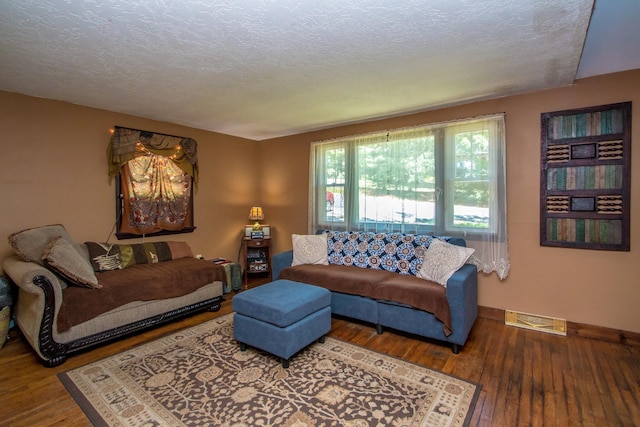 living room featuring hardwood / wood-style floors and a textured ceiling