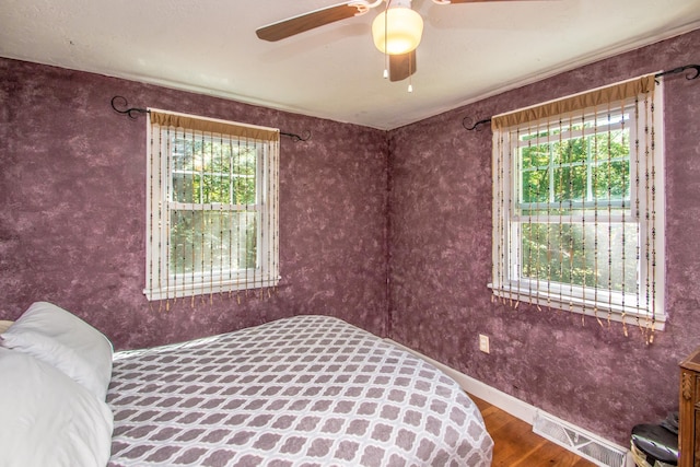 bedroom featuring hardwood / wood-style flooring and multiple windows