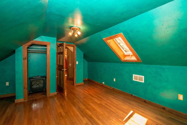 bonus room featuring hardwood / wood-style floors and lofted ceiling with skylight