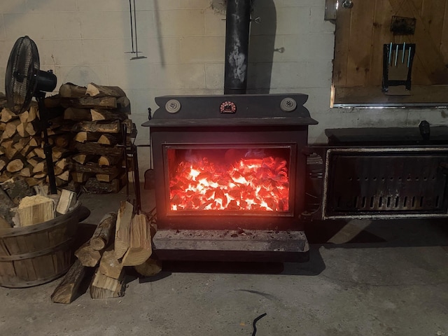 interior details featuring concrete floors and a wood stove