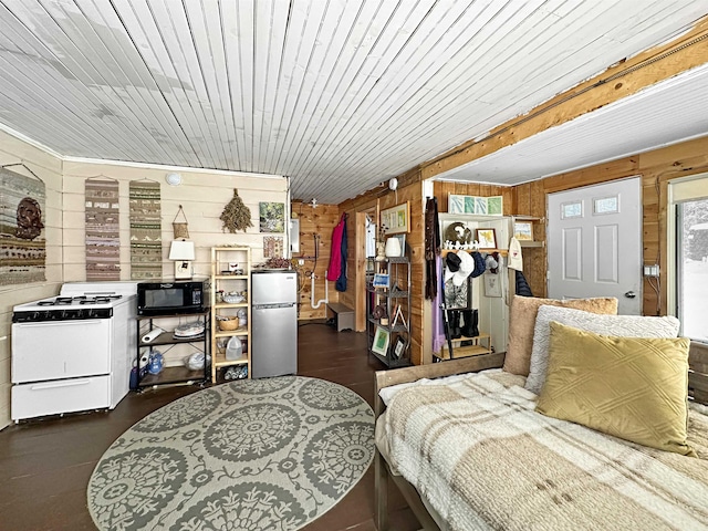 bedroom with wood ceiling, wooden walls, and stainless steel refrigerator