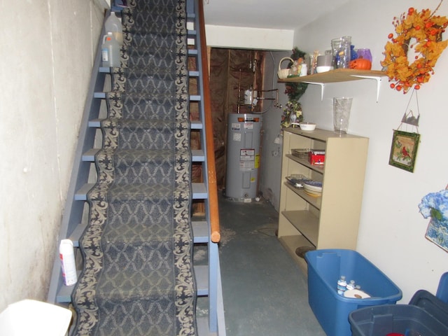 staircase with concrete flooring and electric water heater