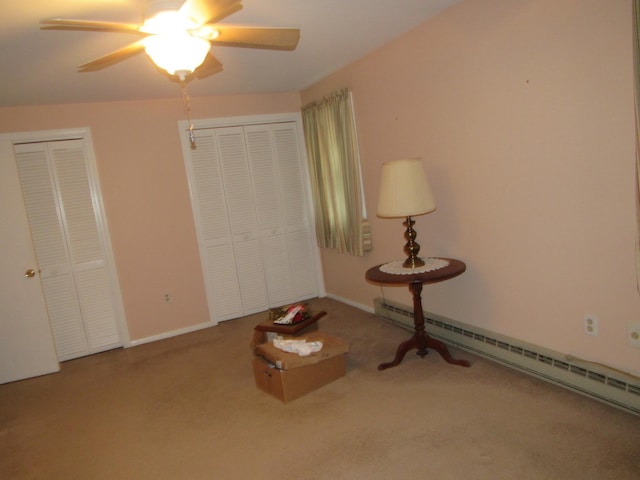 unfurnished room featuring a baseboard heating unit, carpet floors, and ceiling fan